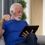 Shocked frustrated senior mature man reading shocking online news at home. Stressed worried elderly male confused by bad news or computer problem